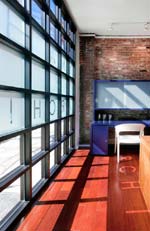 Nicole Migeon Architect Studio and Gallery, NYC: the interior highlights restored brick walls and millwork desks