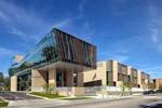 University of Chicago Laboratory Schools Earl Shapiro Hall: The library hovers over the entrance, a powerful symbol of books and the history of knowledge, floating over a glassy lobby space welcoming all to a place of learning.