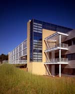 Balconies serve as outdoor breakout spaces for National Wildlife Federation staff. A metal trellis for deciduous vines forms a sunscreen wall on the far portion of the façade.