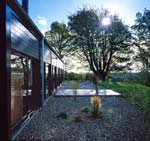 A slate and gravel patio extends the Cedar House living space into the garden.