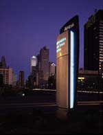 The sleek Acela signage program includes exterior station identification pylons, internally illuminated at night, as seen here in Philadelphia.