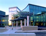 ADC Telecommunications: front entrance with curved glass and columned entry leading into lobby