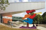 Beecher School: An 18-foot-tall “dancing” caraytid, designed by architect and sculptor Barry Svigals, supports the school’s new entrance canopy. The abstract steel figure represents two mythical characters: a Gideon calling the students to school and a Pied Piper, who, if the promise of education is not received, will call the students away.